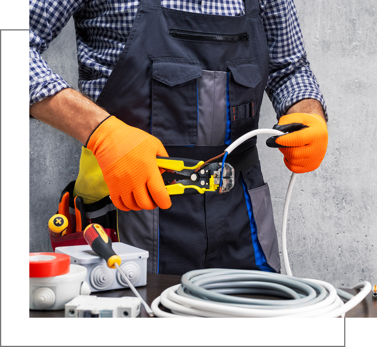 Person handling electrical cables and tools