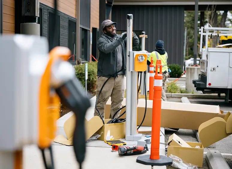 Men setting up EV charging equipment