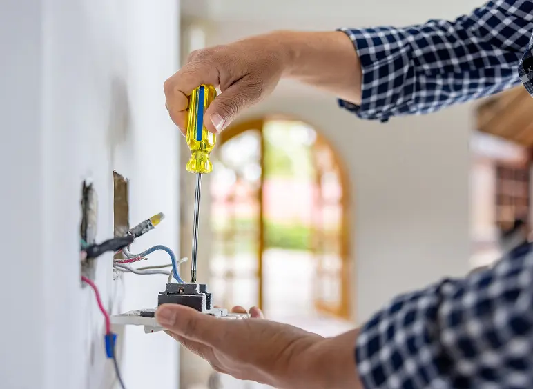 Electrician wiring a wall socket