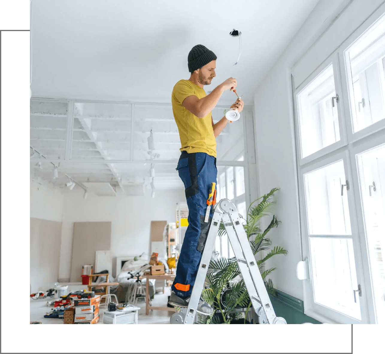Man on ladder installing light