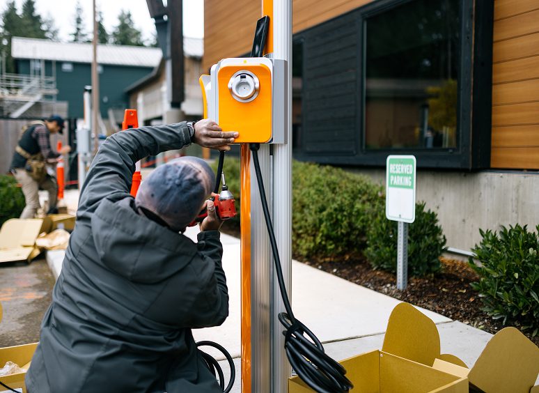 Technician setting up EV charger outdoors