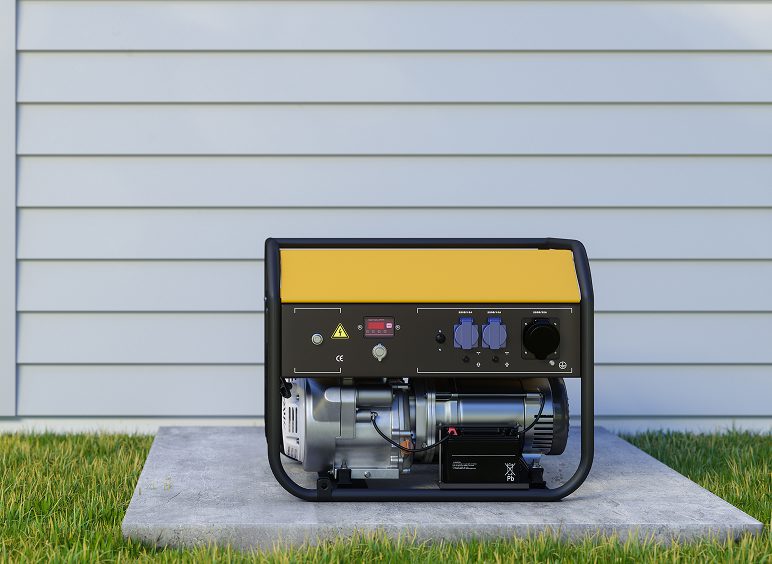 Portable generator on concrete slab outdoors.